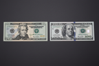 Stack of US $20 and $100 bills representing the most counterfeited denominations